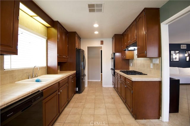45011 16th St W, Lancaster, CA 93534 - kitchen with black appliances, tasteful backsplash, light tile patterned floors, tile counters, and recessed lighting
