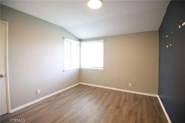 45011 16th St W, Lancaster, CA 93534 - unfurnished room featuring vaulted ceiling and wood finished floors
