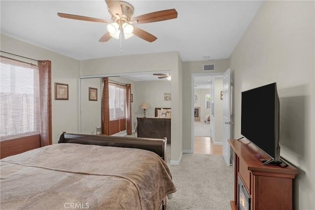 12674 Metate Ln, Poway, CA 92064 - bedroom featuring multiple windows, light carpet, a ceiling fan, and a closet