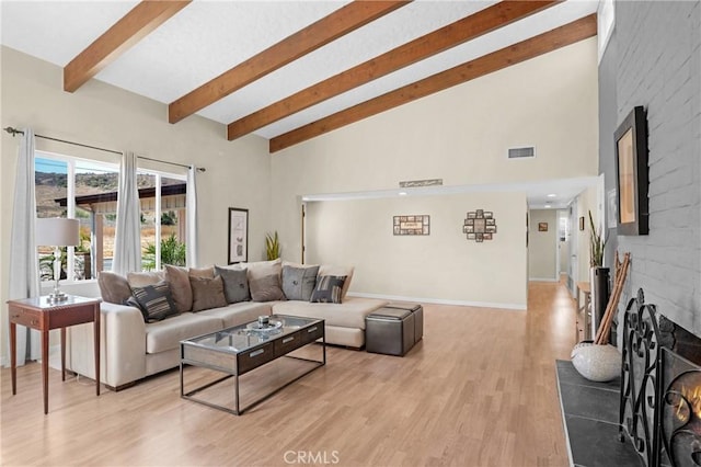 12674 Metate Ln, Poway, CA 92064 - living area with a fireplace, beam ceiling, light wood-style floors, and high vaulted ceiling