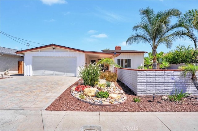 12674 Metate Ln, Poway, CA 92064 - ranch-style house with decorative driveway, a garage, and a chimney