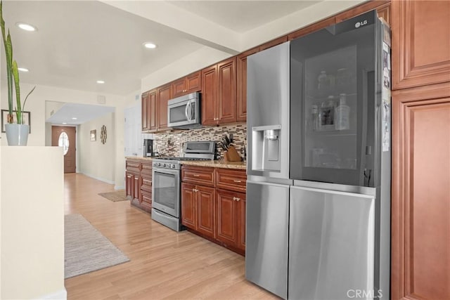 12674 Metate Ln, Poway, CA 92064 - kitchen with stainless steel appliances, light wood finished floors, backsplash, recessed lighting, and brown cabinets