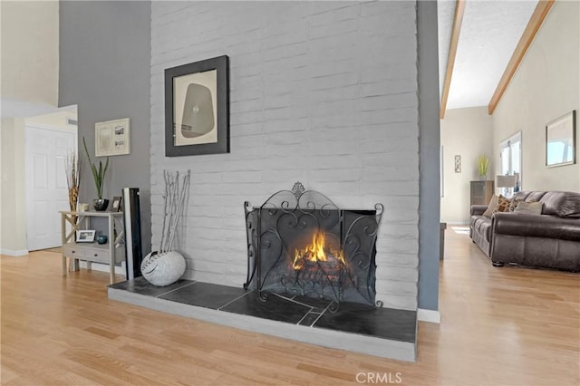 12674 Metate Ln, Poway, CA 92064 - living area with wood finished floors, high vaulted ceiling, and a brick fireplace