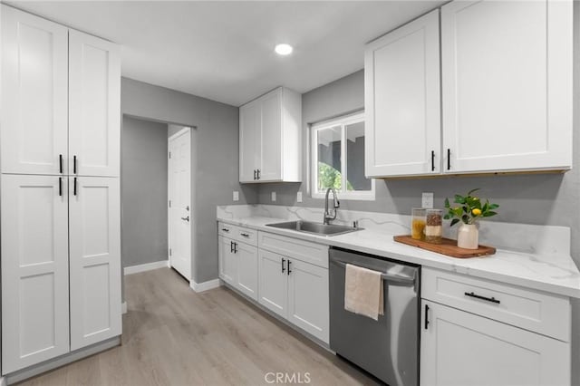 11343 1st Ave, Hesperia, CA 92345 - kitchen featuring stainless steel dishwasher, light wood finished floors, white cabinetry, and light stone countertops