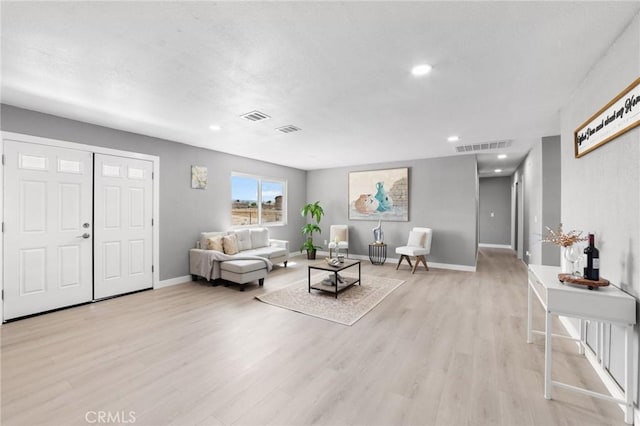 11343 1st Ave, Hesperia, CA 92345 - living room featuring light wood-type flooring and recessed lighting