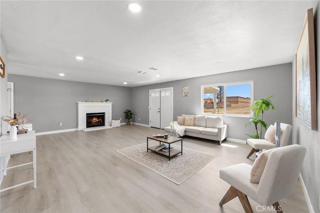 11343 1st Ave, Hesperia, CA 92345 - living area with a fireplace, wood finished floors, and recessed lighting
