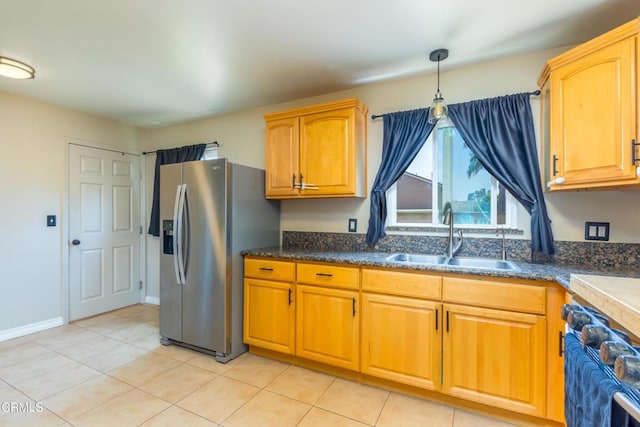 312 Lafayette Dr, Oxnard, CA 93036 - kitchen with stainless steel refrigerator with ice dispenser, light tile patterned flooring, hanging light fixtures, and dark countertops