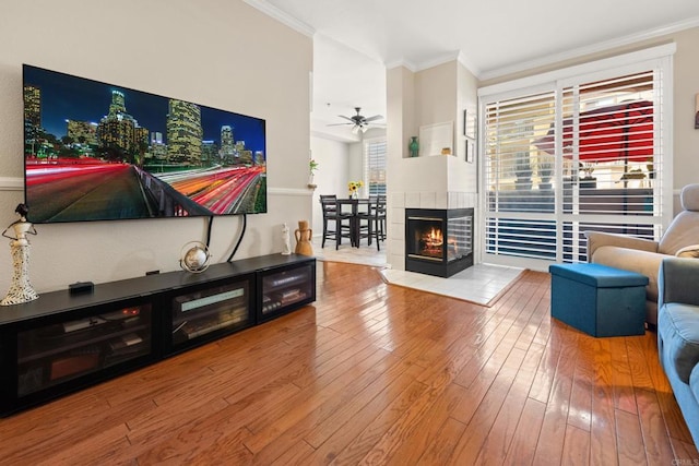 640 Camino De La Reina Unit 1108, San Diego, CA 92108 - living area featuring crown molding, wood-type flooring, a ceiling fan, and a tiled fireplace