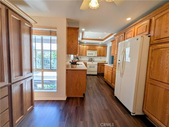 5499 Paseo Del Lago W Unit 3D, Laguna Woods, CA 92637 - kitchen with white appliances, dark wood-style floors, a tray ceiling, light countertops, and recessed lighting