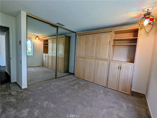 5499 Paseo Del Lago W Unit 3D, Laguna Woods, CA 92637 - unfurnished bedroom with carpet floors, a textured ceiling, and a closet