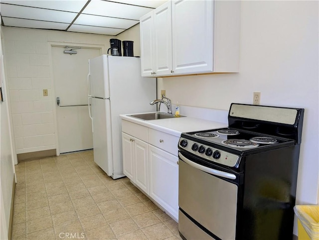 5499 Paseo Del Lago W Unit 3D, Laguna Woods, CA 92637 - kitchen featuring stainless steel range with electric stovetop, white cabinets, light countertops, and freestanding refrigerator