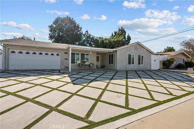11209 Forbes Ave, Granada Hills, CA 91344 - ranch-style home featuring stucco siding, a garage, and driveway