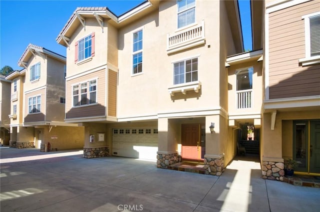 717 Arcadia Ave Unit C, Arcadia, CA 91007 - view of front of property featuring stucco siding, a garage, stone siding, and concrete driveway