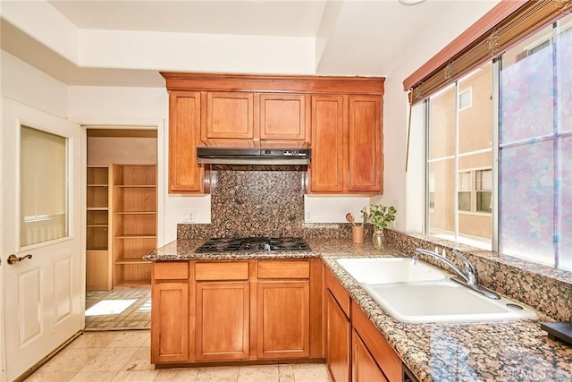 717 Arcadia Ave Unit C, Arcadia, CA 91007 - kitchen featuring under cabinet range hood, stainless steel gas cooktop, backsplash, and brown cabinetry
