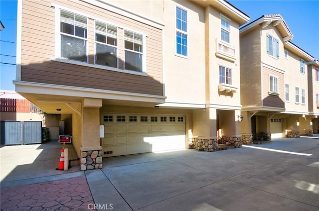 717 Arcadia Ave Unit C, Arcadia, CA 91007 - view of front of property featuring stucco siding, an attached garage, driveway, and stone siding