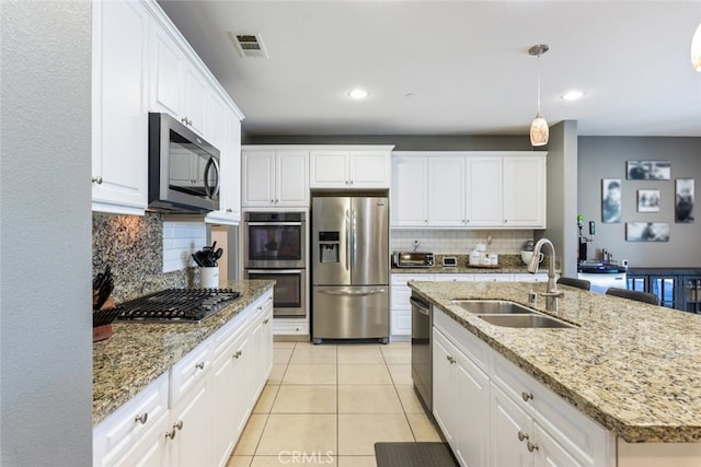31572 Via Del Paso, Winchester, CA 92596 - kitchen featuring stainless steel appliances, tasteful backsplash, white cabinetry, recessed lighting, and light tile patterned floors