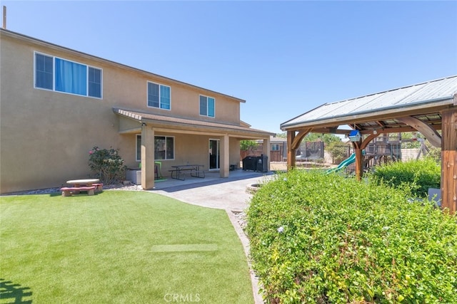 31572 Via Del Paso, Winchester, CA 92596 - back of house with stucco siding, a patio, and a playground