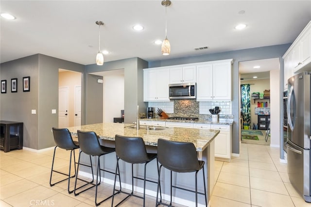 31572 Via Del Paso, Winchester, CA 92596 - kitchen featuring appliances with stainless steel finishes, backsplash, light tile patterned floors, white cabinets, and recessed lighting