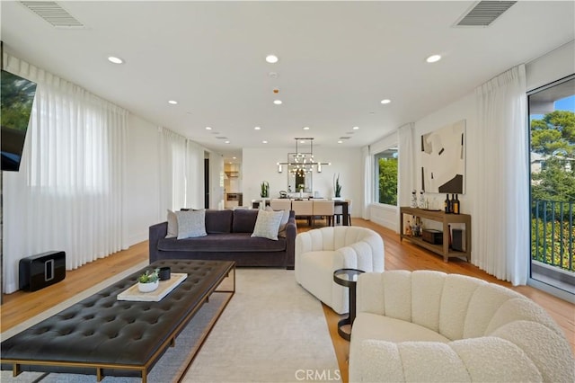 35481/2 Multiview Dr, Los Angeles, CA 90068 - living area with wood finished floors, plenty of natural light, a chandelier, and recessed lighting