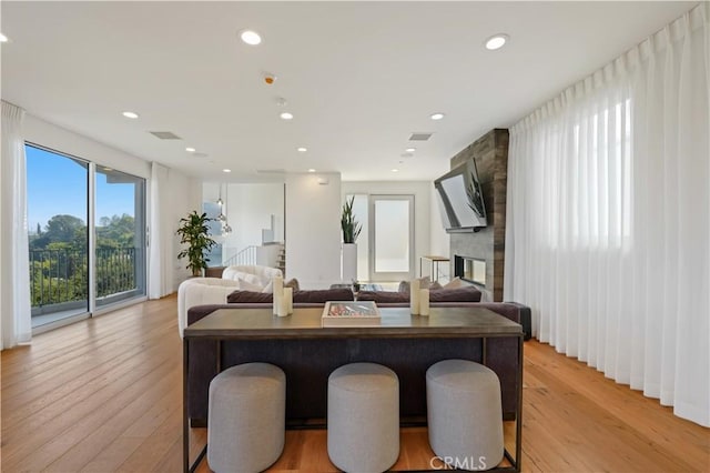 35481/2 Multiview Dr, Los Angeles, CA 90068 - living room featuring light wood-type flooring, a stone fireplace, and recessed lighting