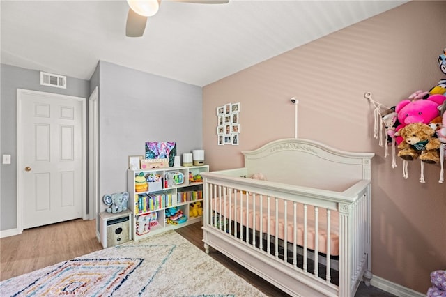 3732 Calle Monada, Riverside, CA 92503 - bedroom with wood finished floors, ceiling fan, and a nursery area