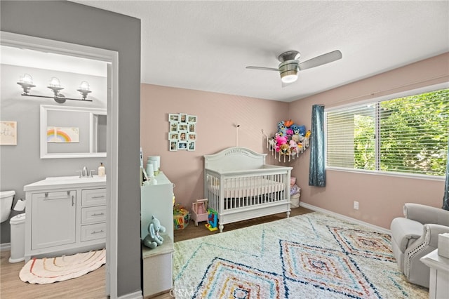 3732 Calle Monada, Riverside, CA 92503 - bedroom with a crib, wood finished floors, and ceiling fan