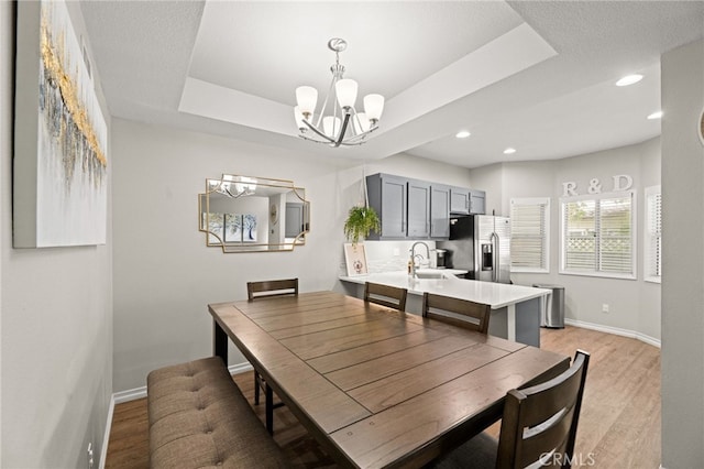 3732 Calle Monada, Riverside, CA 92503 - dining area with a chandelier, light wood-style flooring, recessed lighting, and a raised ceiling
