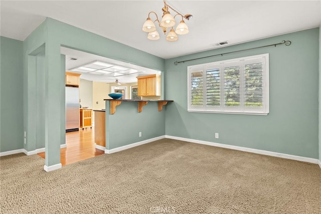 10 Roseanna Ct, Chico, CA 95973 - unfurnished living room featuring carpet and a chandelier