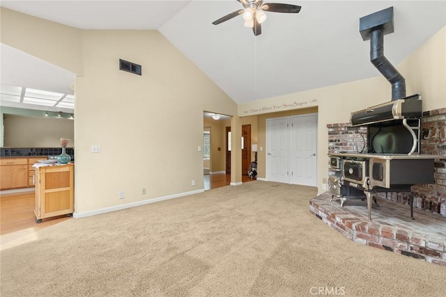 10 Roseanna Ct, Chico, CA 95973 - living room featuring a wood stove, a ceiling fan, light colored carpet, and high vaulted ceiling