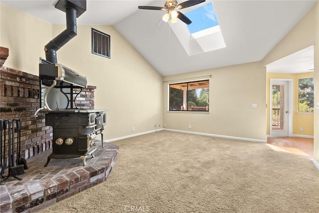 10 Roseanna Ct, Chico, CA 95973 - carpeted living area featuring a wood stove, ceiling fan, a skylight, and high vaulted ceiling