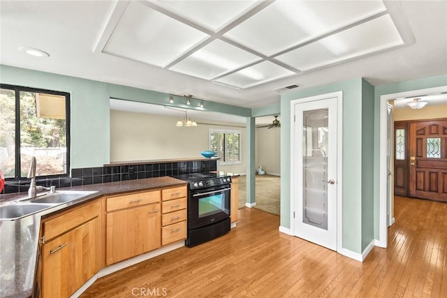 10 Roseanna Ct, Chico, CA 95973 - kitchen with black range, light wood-type flooring, dark countertops, recessed lighting, and a peninsula
