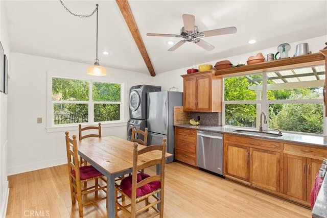 10 Roseanna Ct, Chico, CA 95973 - kitchen featuring appliances with stainless steel finishes, stacked washer / dryer, brown cabinetry, tasteful backsplash, and beamed ceiling