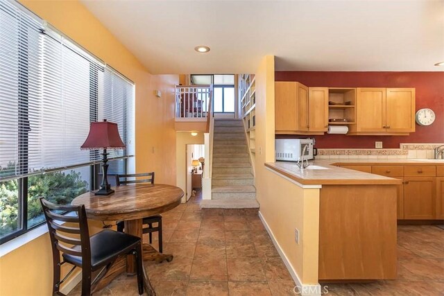 1410 Verde Canyon Rd, Arroyo Grande, CA 93420 - kitchen with stainless steel microwave, light brown cabinets, open shelves, and plenty of natural light