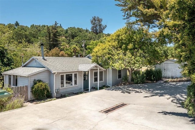 1410 Verde Canyon Rd, Arroyo Grande, CA 93420 - view of front of property featuring a shed, roof with shingles, and a view of trees