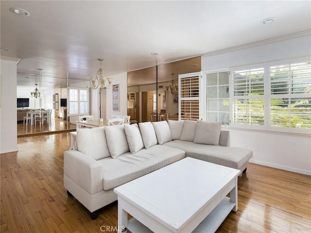 13404 Arcturus Ave, Gardena, CA 90249 - living area with a chandelier, wood finished floors, and crown molding