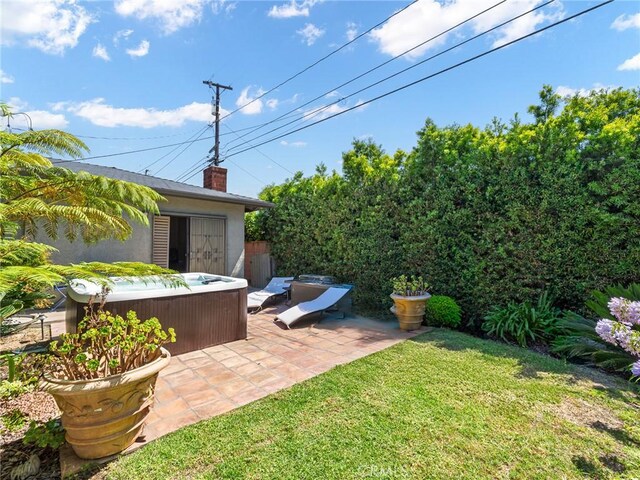 13404 Arcturus Ave, Gardena, CA 90249 - view of grassy yard featuring a hot tub, a patio area, and an outdoor structure