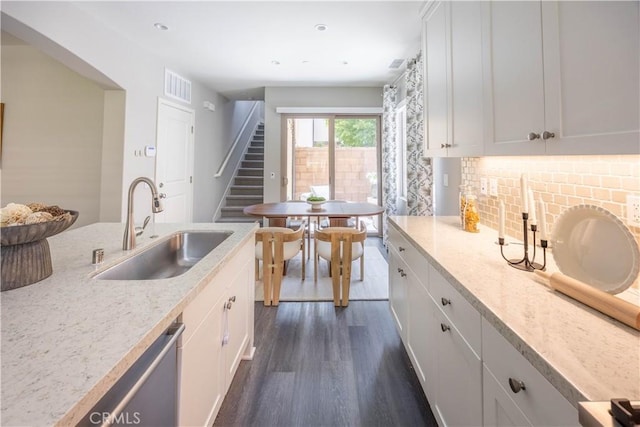 134 Milky Way, Irvine, CA 92618 - kitchen with dark wood-style floors, white cabinets, backsplash, dishwasher, and recessed lighting