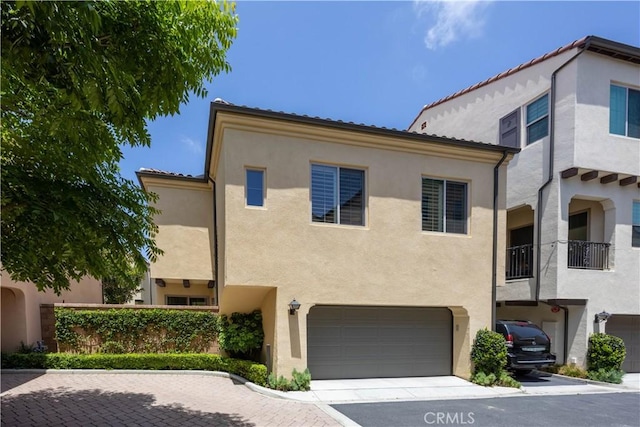 134 Milky Way, Irvine, CA 92618 - mediterranean / spanish house featuring stucco siding, an attached garage, and driveway