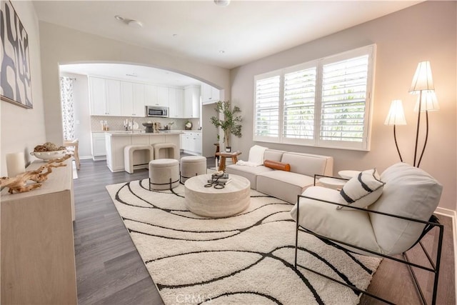 134 Milky Way, Irvine, CA 92618 - living area featuring arched walkways and dark wood-style flooring