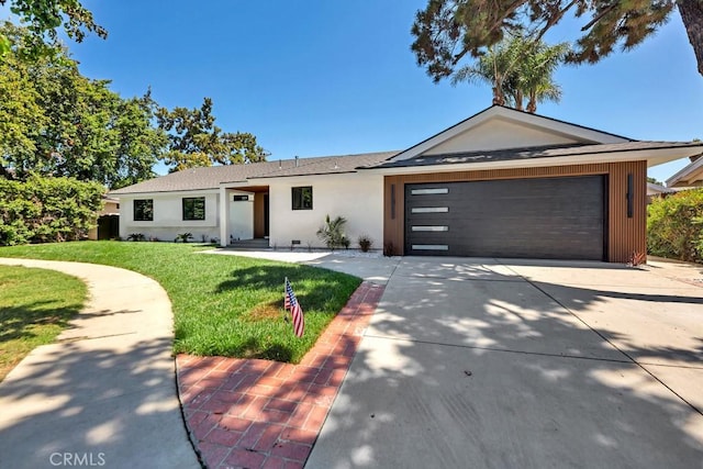 20646 Hatton St, Winnetka, CA 91306 - ranch-style house featuring a front yard, a garage, driveway, stucco siding, and roof with shingles