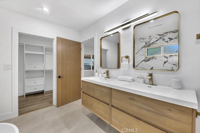 20646 Hatton St, Winnetka, CA 91306 - bathroom featuring double vanity and a walk in closet
