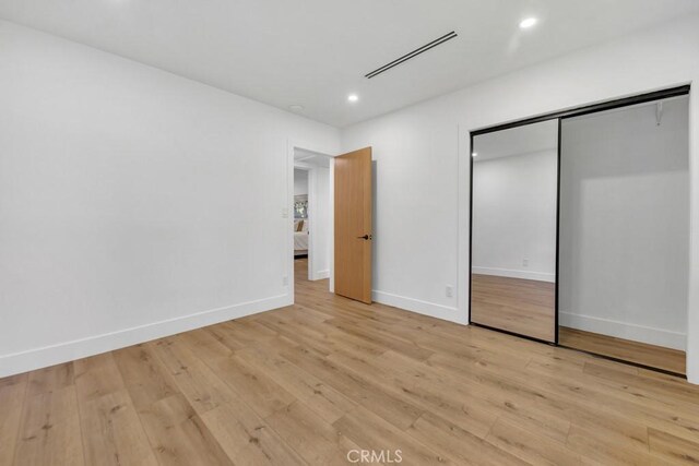20646 Hatton St, Winnetka, CA 91306 - unfurnished bedroom featuring light wood-type flooring, recessed lighting, and a closet