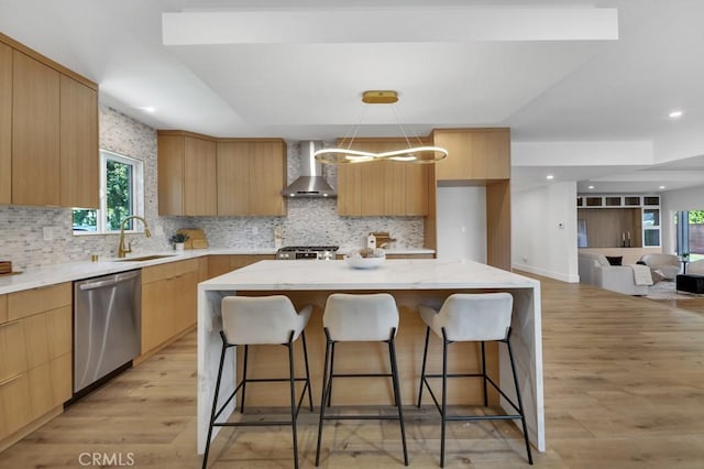 20646 Hatton St, Winnetka, CA 91306 - kitchen featuring stainless steel dishwasher, wall chimney exhaust hood, modern cabinets, light wood finished floors, and a breakfast bar