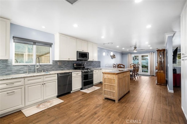 7985 Stella St, Riverside, CA 92504 - kitchen with stainless steel appliances, ceiling fan, decorative backsplash, white cabinetry, and recessed lighting