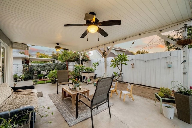 7985 Stella St, Riverside, CA 92504 - patio terrace at dusk with a patio, a fenced backyard, and ceiling fan