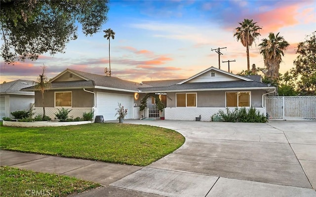 7985 Stella St, Riverside, CA 92504 - single story home featuring stucco siding, concrete driveway, an attached garage, and a gate