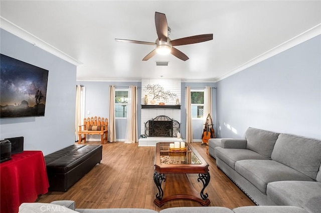 7985 Stella St, Riverside, CA 92504 - living area with hardwood / wood-style flooring, ceiling fan, a brick fireplace, and ornamental molding