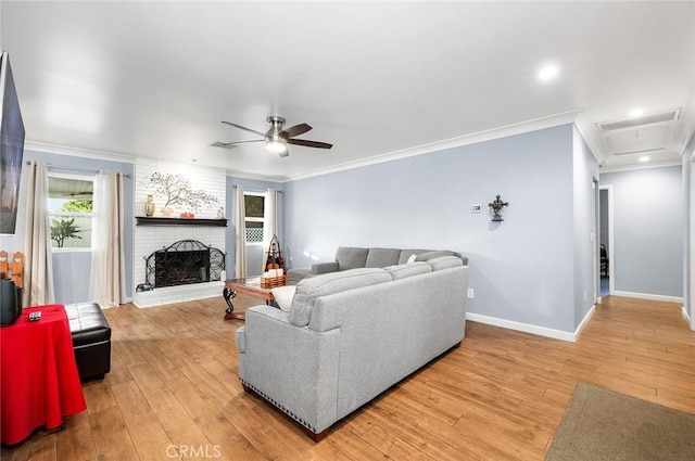 7985 Stella St, Riverside, CA 92504 - living area featuring ornamental molding, a ceiling fan, light wood-style flooring, a fireplace, and recessed lighting