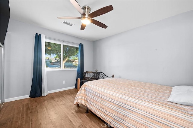 7985 Stella St, Riverside, CA 92504 - bedroom with wood finished floors and a ceiling fan