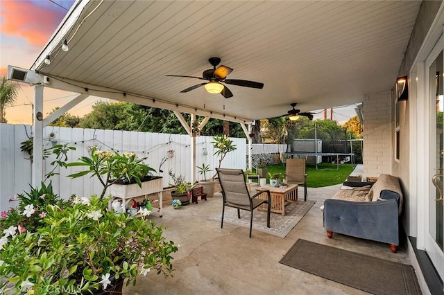 7985 Stella St, Riverside, CA 92504 - fenced backyard featuring a trampoline, a patio area, and ceiling fan